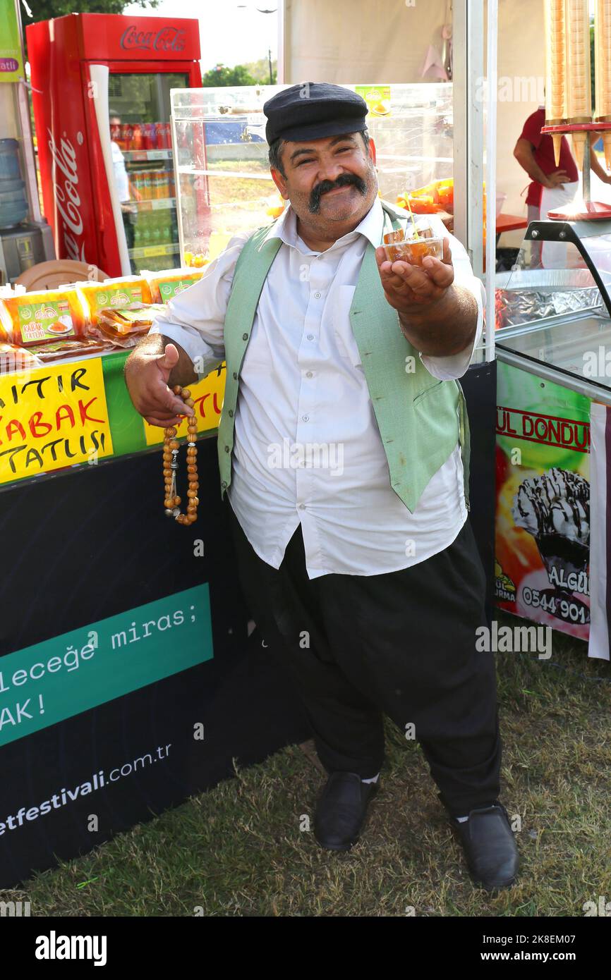 Unidentified Man in Traditional Adana Outfit and Beads Selling Pumpkin Dessert at The Taste of Adana Festival. October 07,2022 in Adana, Turkey Stock Photo