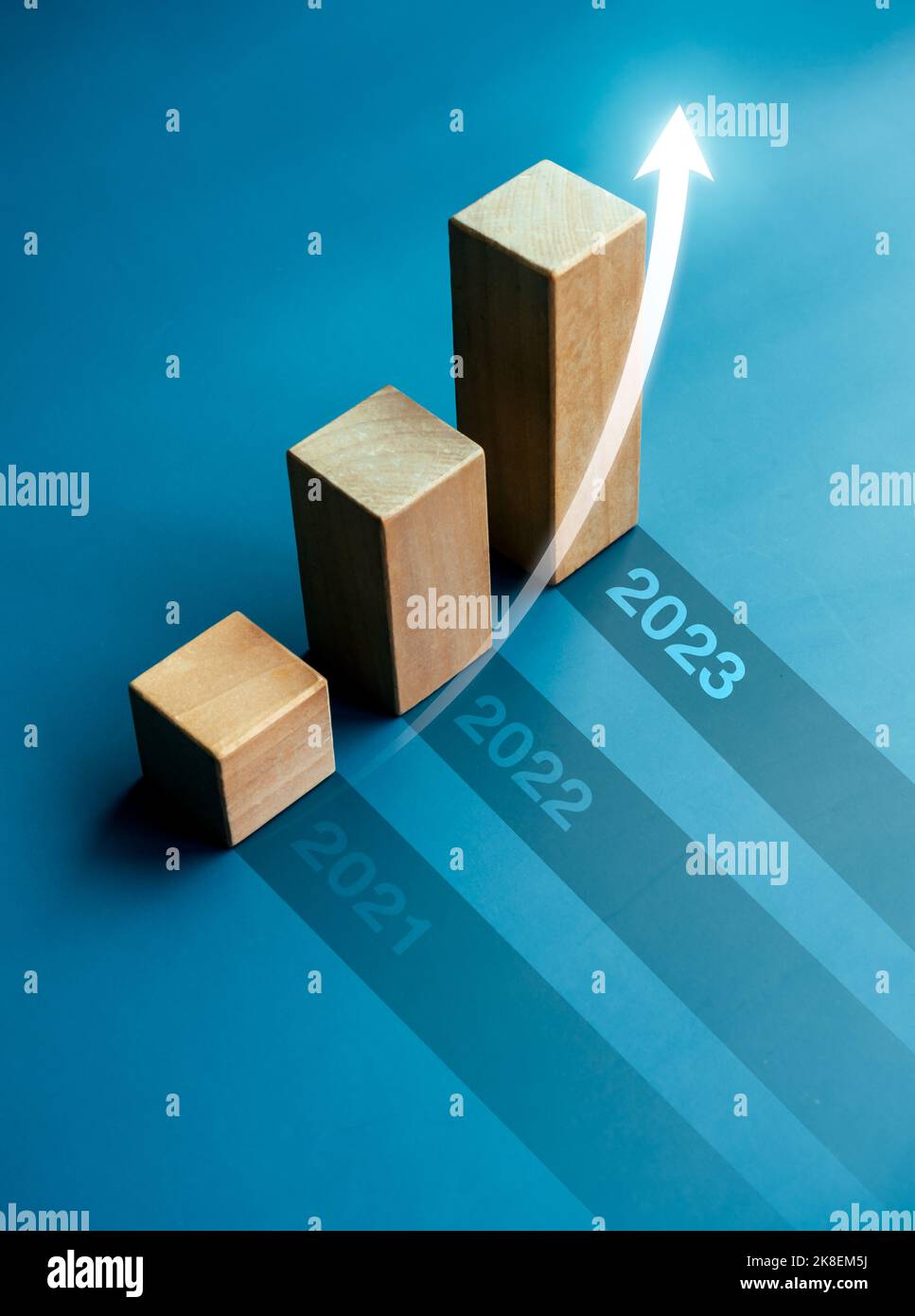 Shining rise up arrow on wooden cube blocks, bar graph chart steps on blue  background with year numbers, 2023, 2022, 2021, vertical style. Business gr  Stock Photo - Alamy