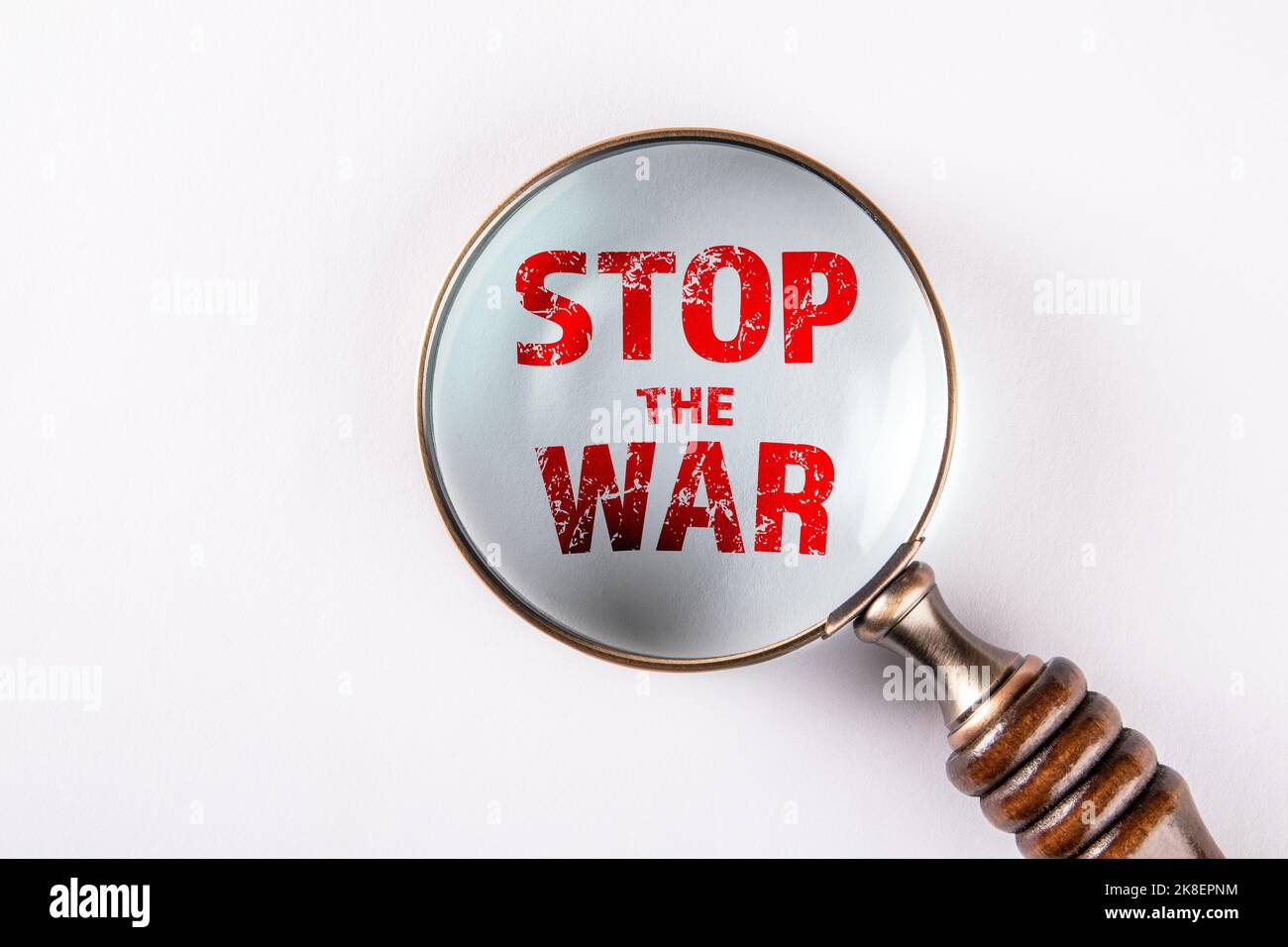 Stop the war. Magnifying glass on a white background. Stock Photo