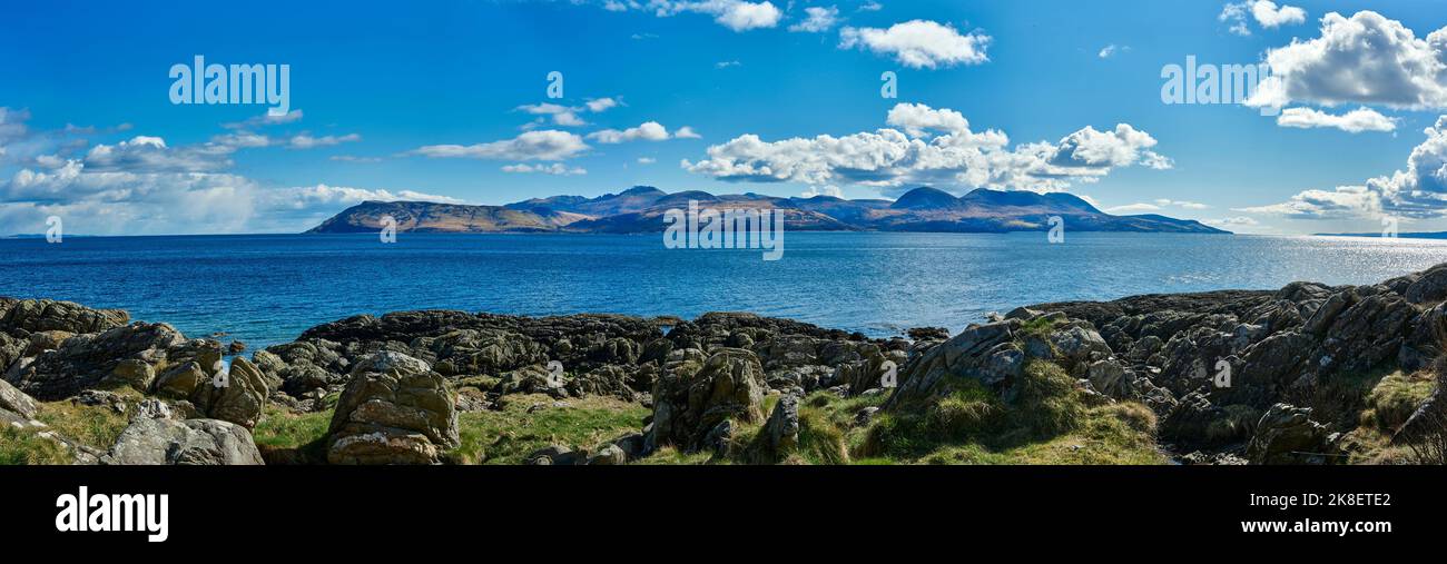 View east from the B8001 by Skipness, from north to south, a panoramic view of the Isle of Arran across the Kilbrannan Sound. Tarbert, Argyll and Bute Stock Photo