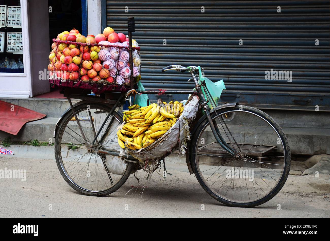 Bicycle cart hawker of nepali man vendor stop on road sale variety