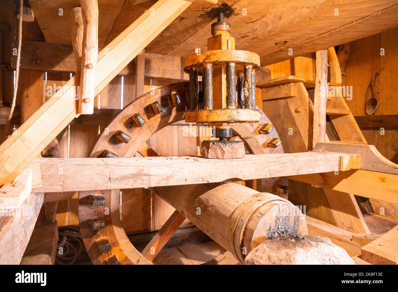 Wooden grinder with gears in a water mill as in the medieval or Viking times Stock Photo