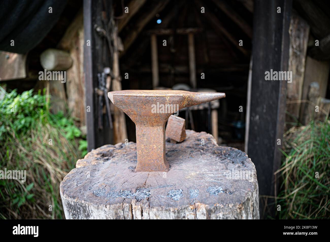 Anvil in front of a medieval blacksmith's hut Stock Photo