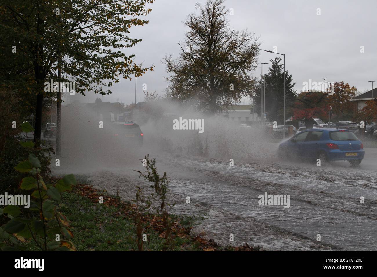 Colchester, UK. 23rd Oct 2022. Heavy thundery showers are causing flash flooding on some roads in Colchester, Essex. There is a Met Office weather warning in place for thunderstorms across the east of England until the early hours of Monday morning. Credit: Eastern Views/Alamy Live News Stock Photo