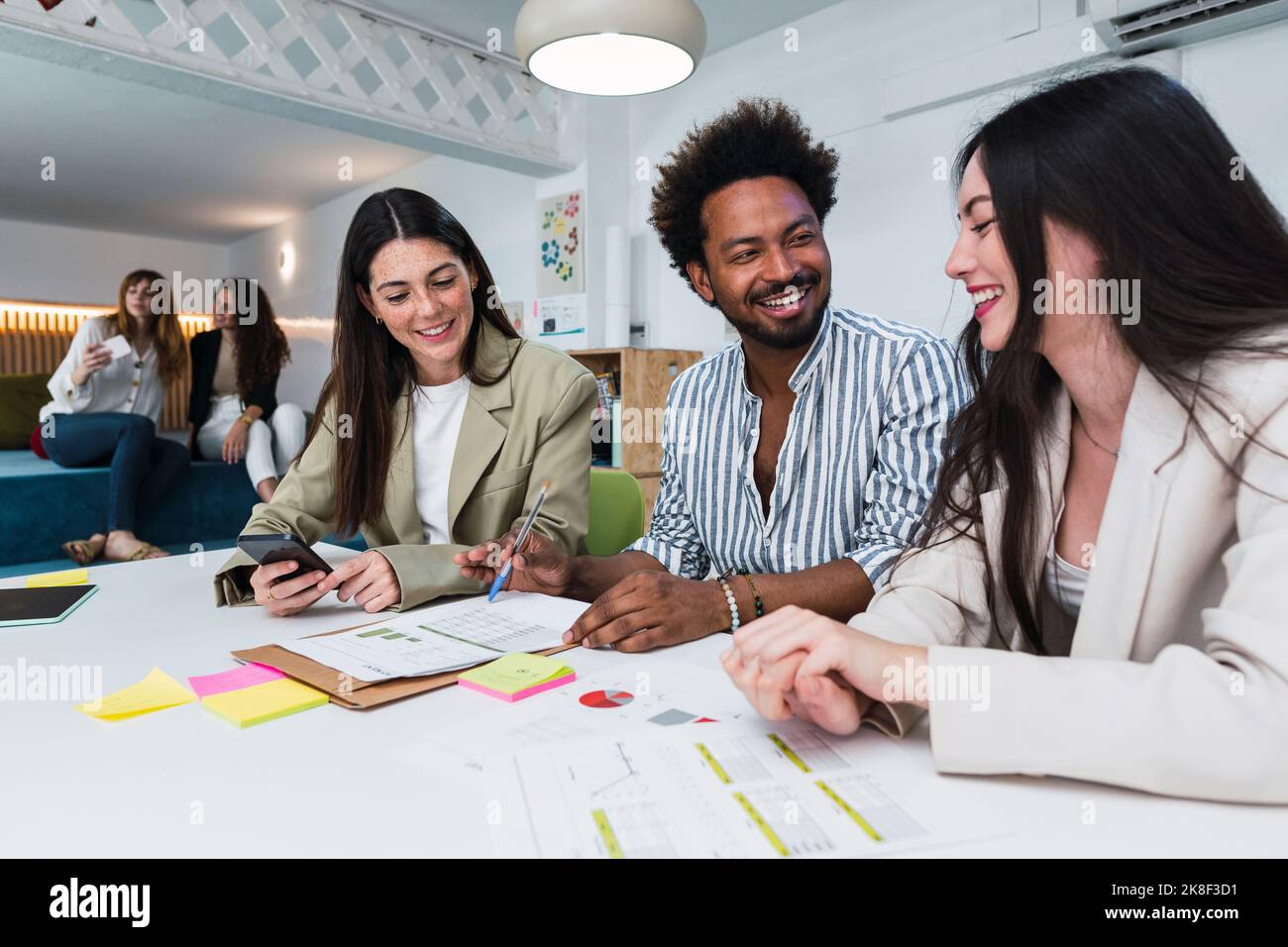 Happy colleagues working together on document in office Stock Photo