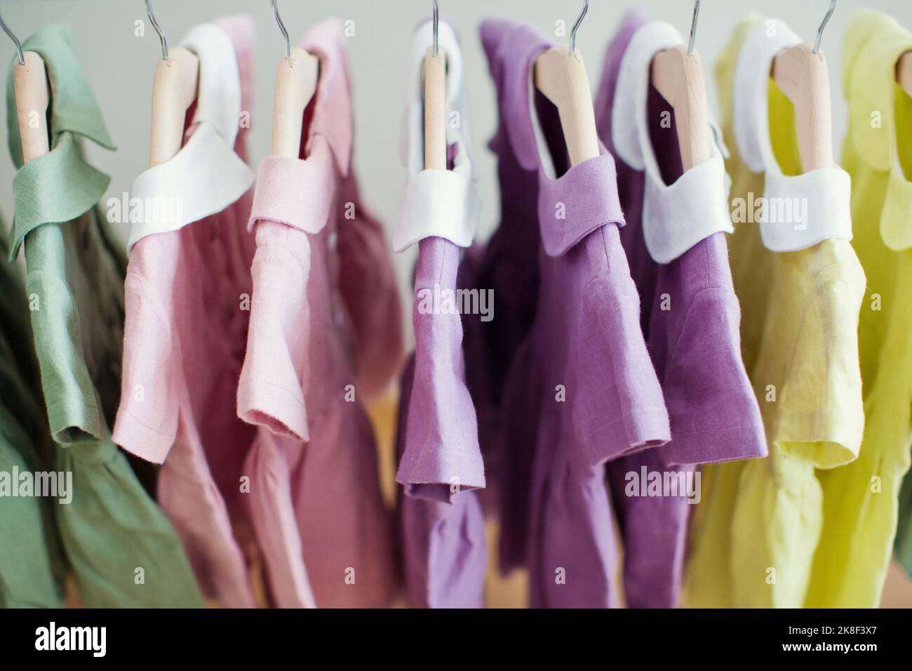 Colorful dresses hanging on rack Stock Photo Alamy