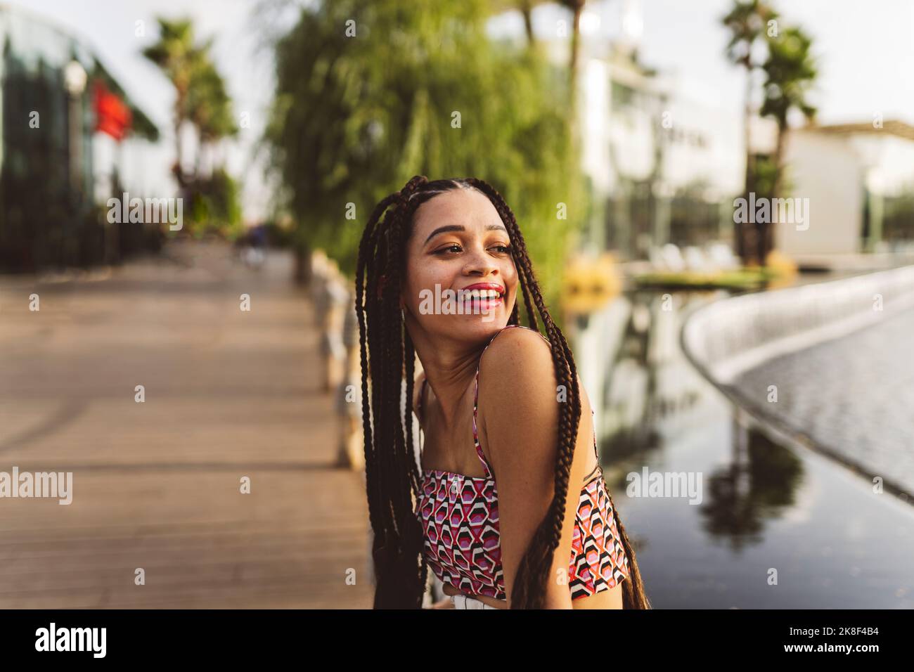 Happy young woman with long braided hair Stock Photo