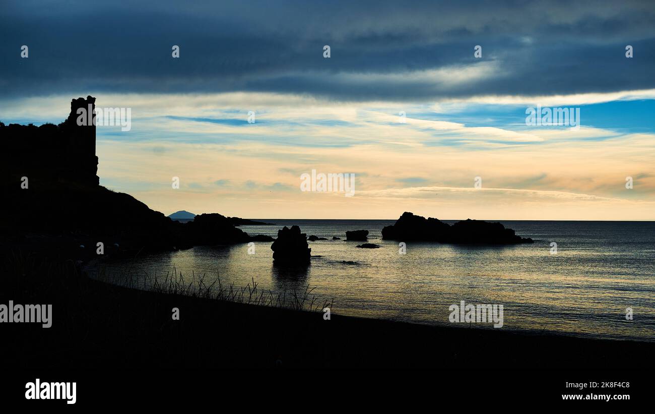Dunure Castle ruins and sunset skies over the sea, Ayrshire, Scotland ...