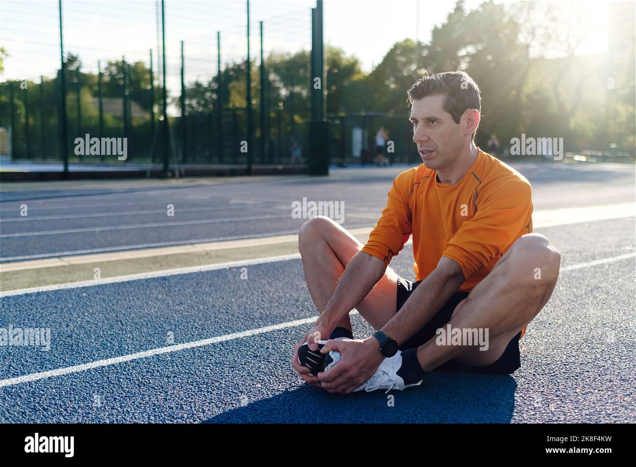Mature male athlete stretching hi-res stock photography and images - Alamy