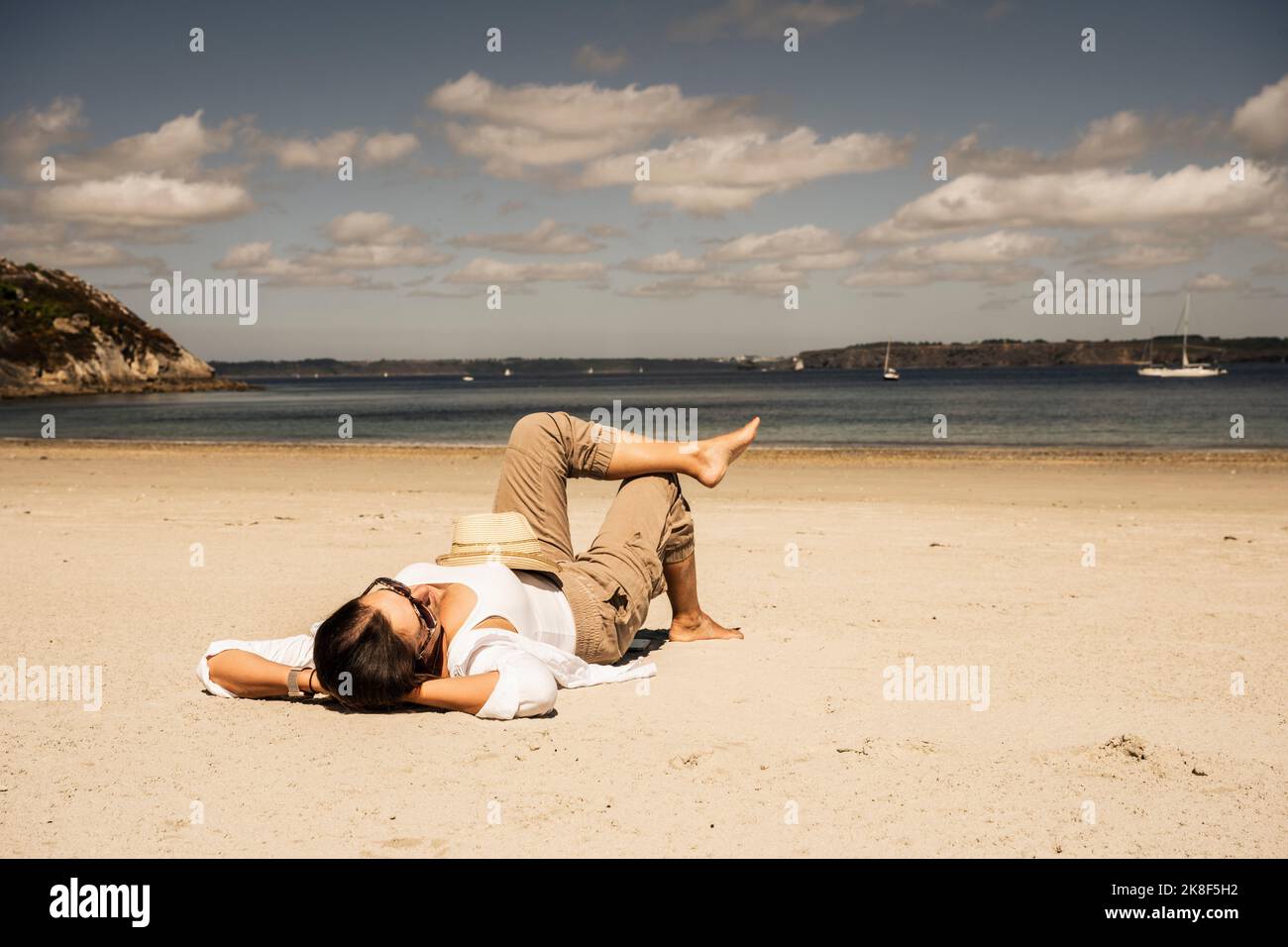 Mature woman relaxing on beach hi-res stock photography and images - Alamy
