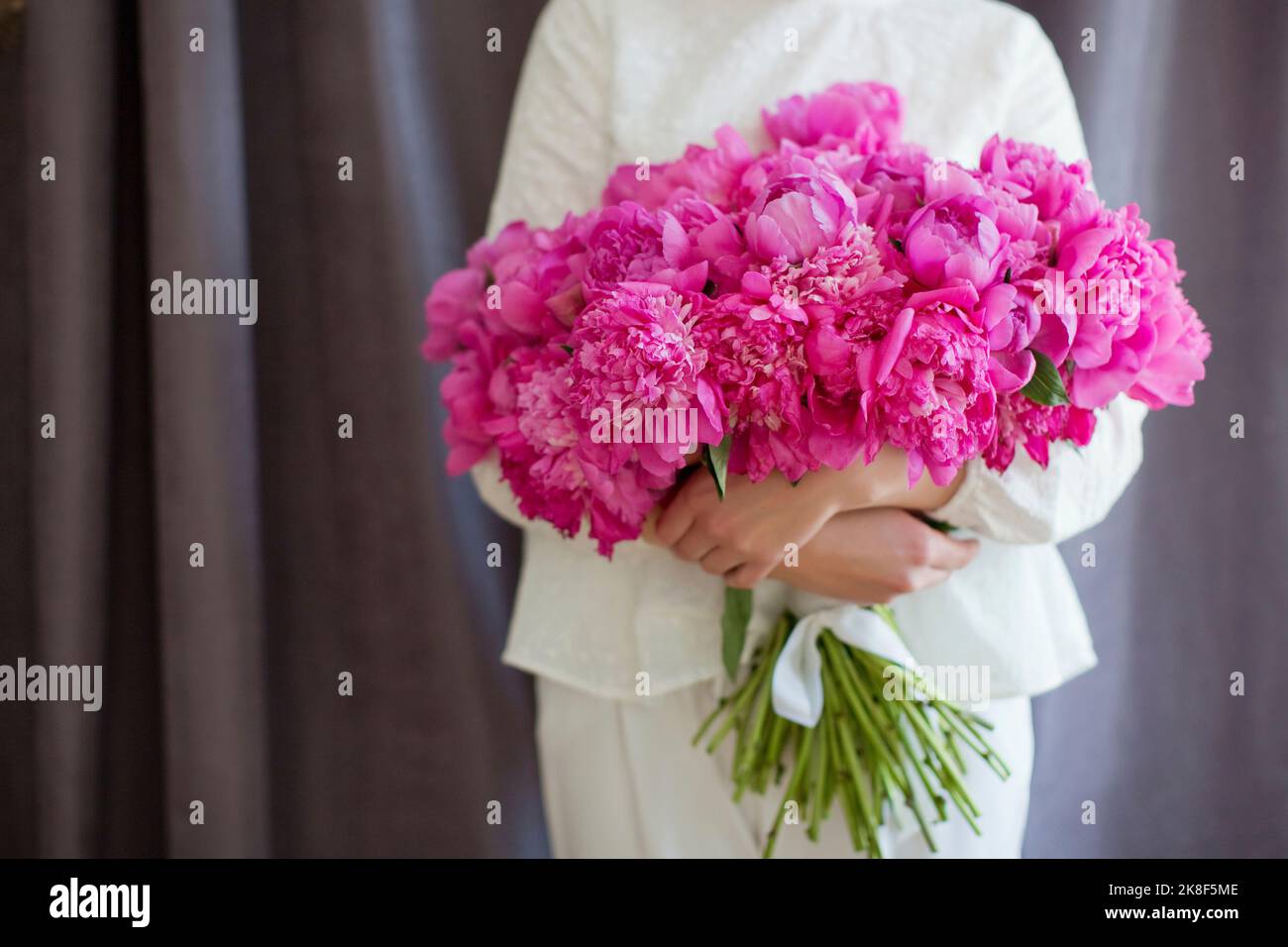 Woman with bouquet of peonies hi-res stock photography and images - Alamy