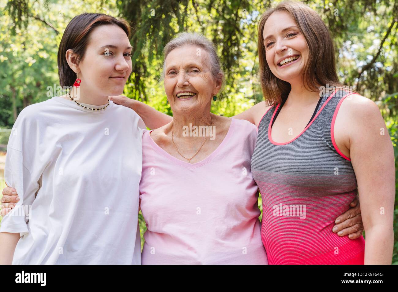 Happy senior woman with daughter and granddaughter standing at park Stock Photo