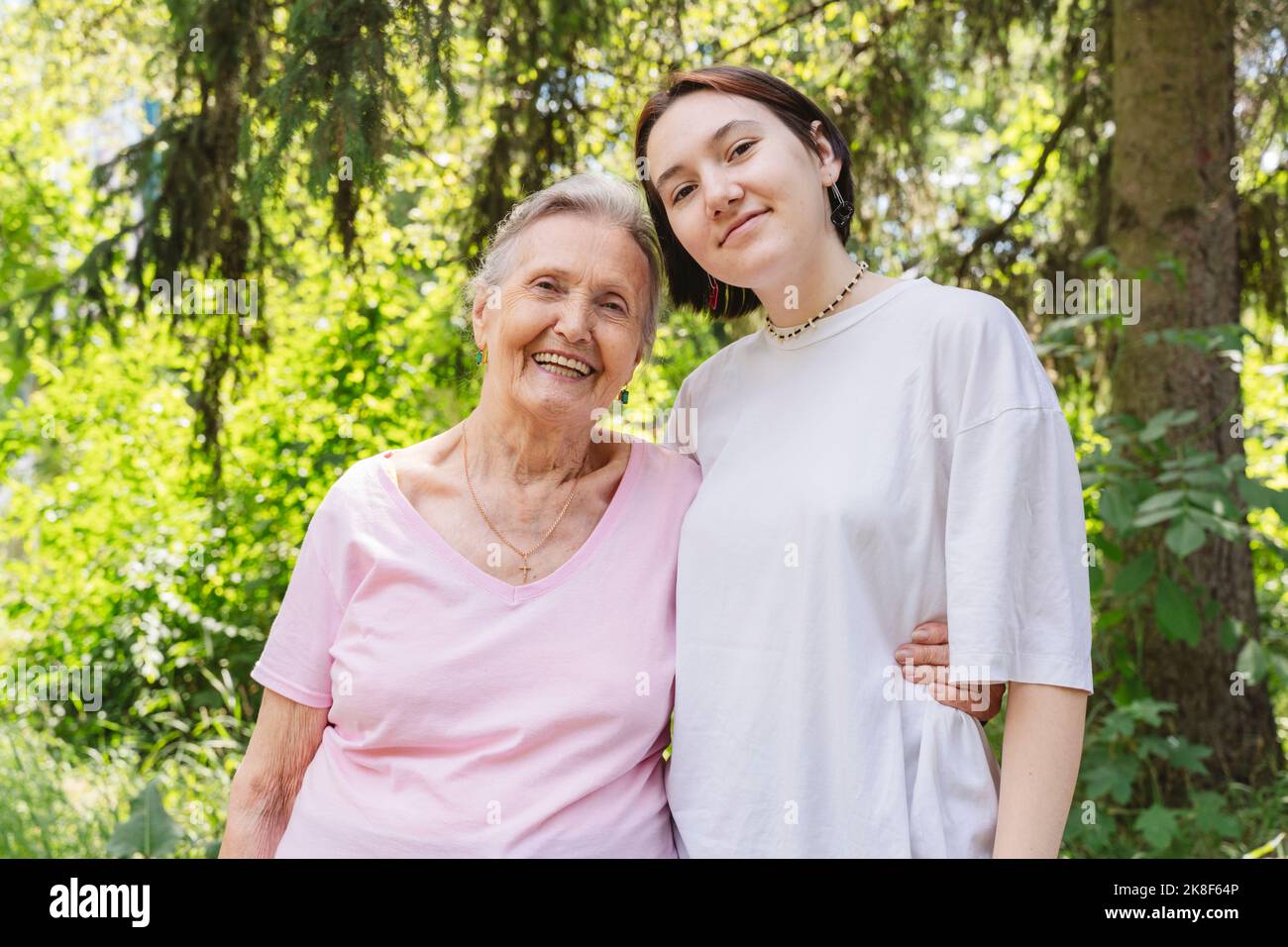 Happy senior woman with granddaughter standing at park Stock Photo