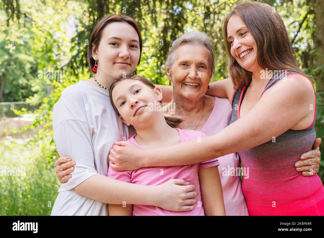 Happy senior woman with family standing together at park Stock Photo