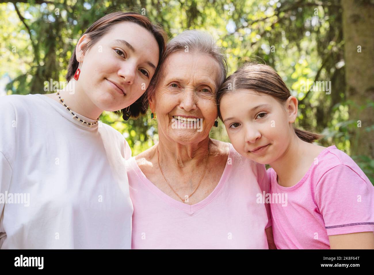 Happy siblings with grandmother standing at park Stock Photo