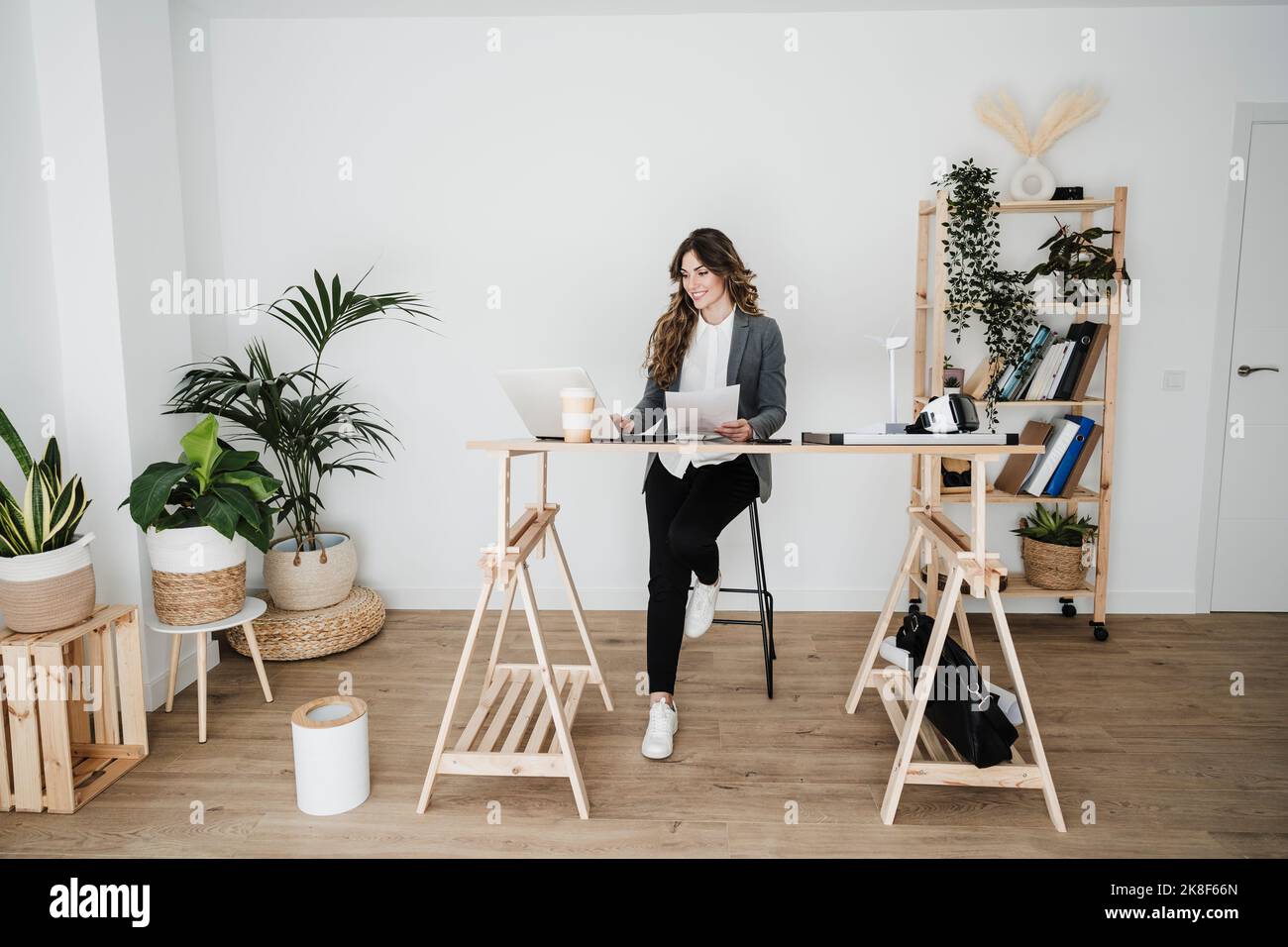Young female engineer working in modern office sitting at desk Stock Photo