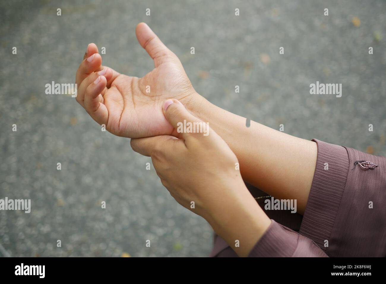 rear view of women suffering pain in hand  Stock Photo