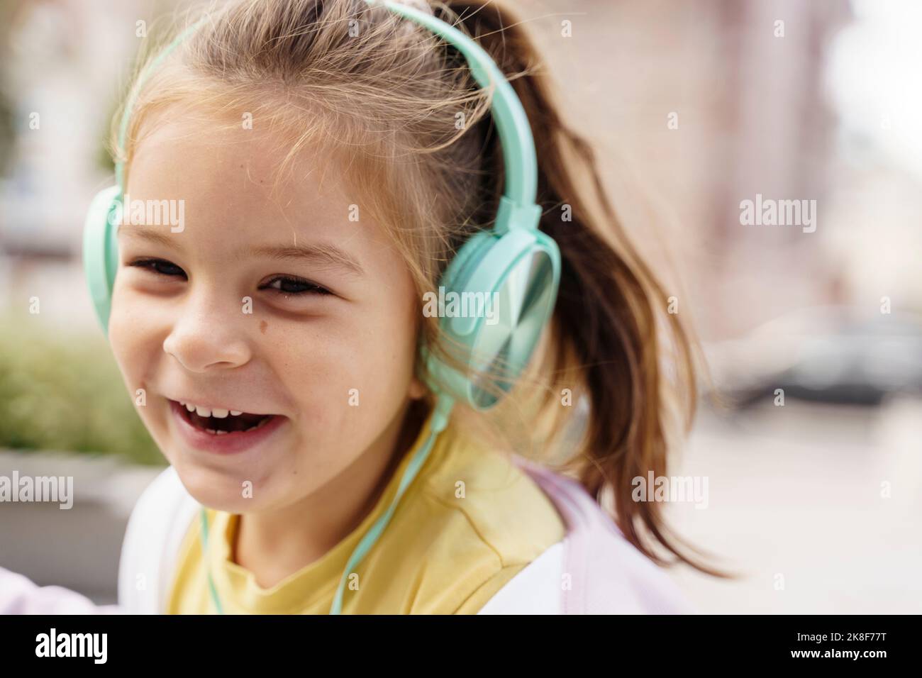 Happy girl listening to music through headphones Stock Photo - Alamy