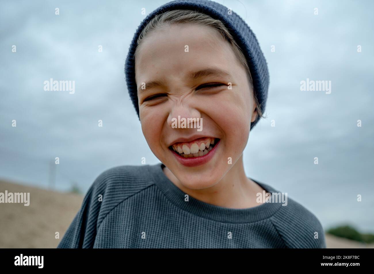 Smiling boy wearing knit hat Stock Photo