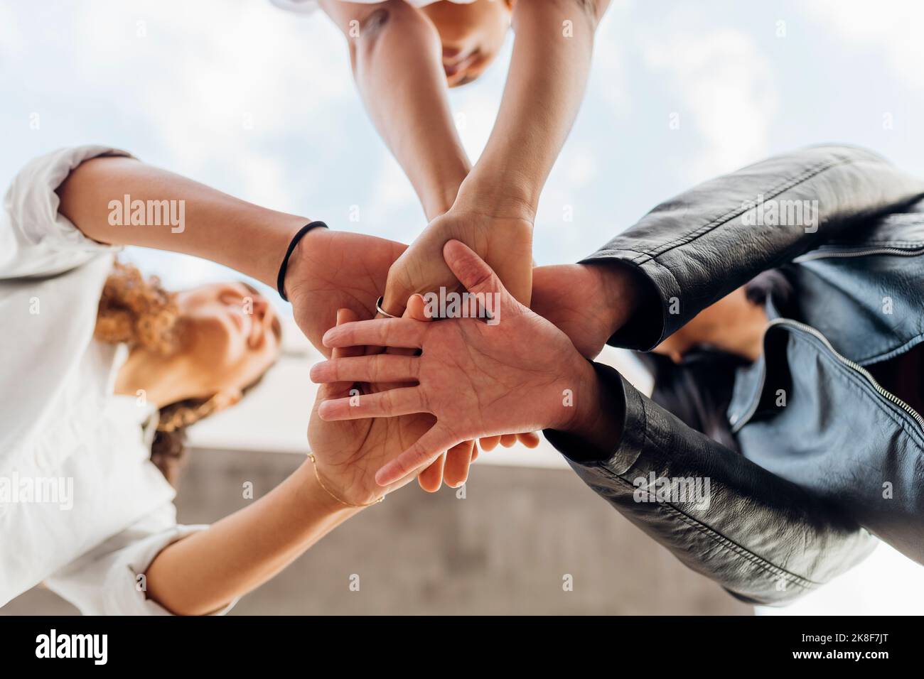 Young women stacking hands together Stock Photo Alamy