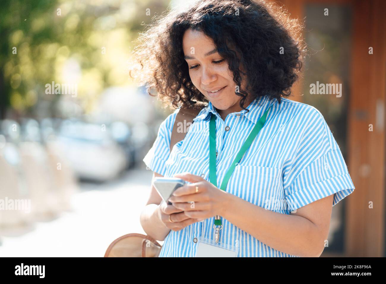 Businesswoman with ID card using smart phone Stock Photo