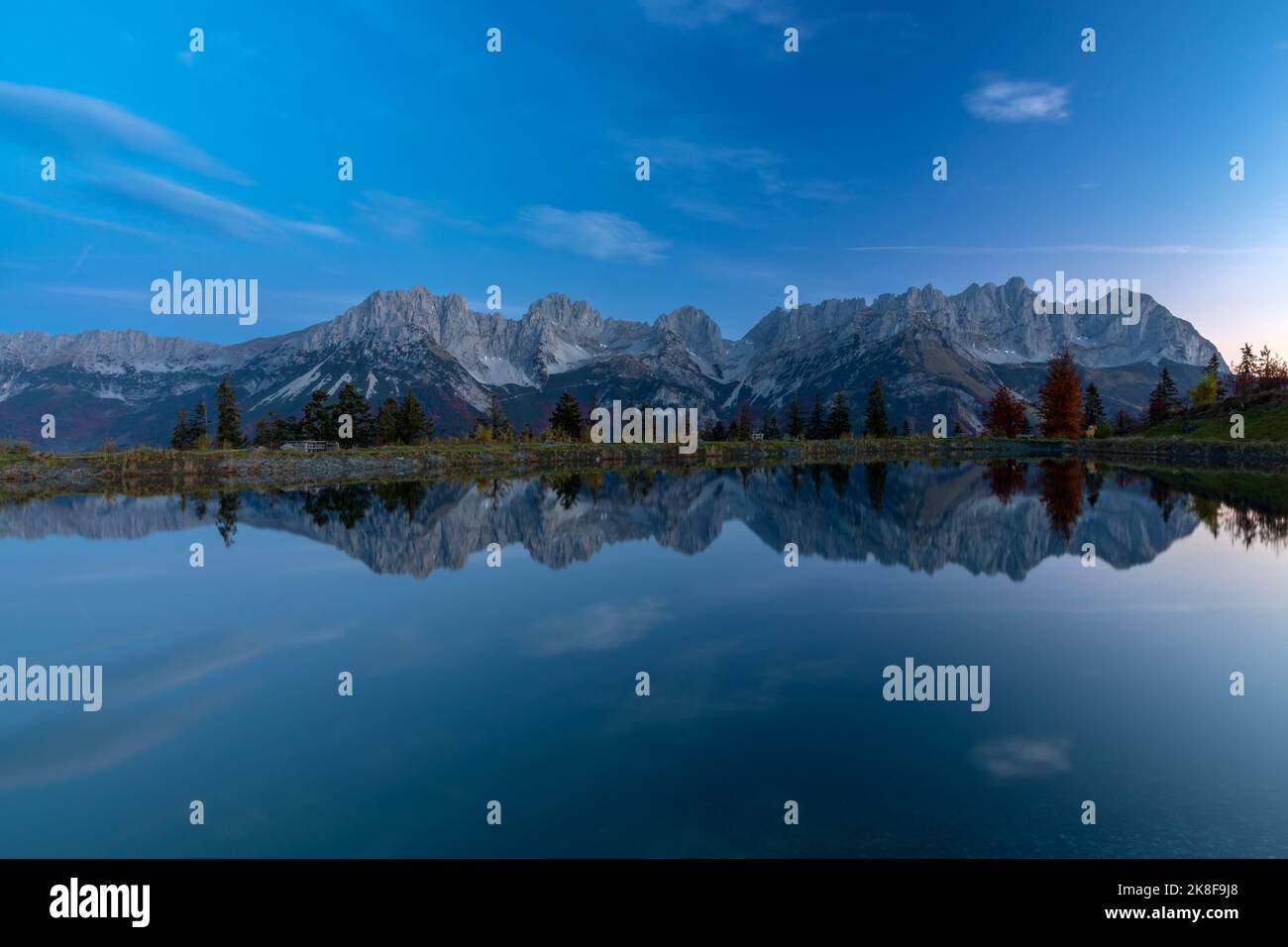 Wilder Kaiser mountains reflected in lake Astbergsee in early morning, Going, Tyrol, Austria Stock Photo