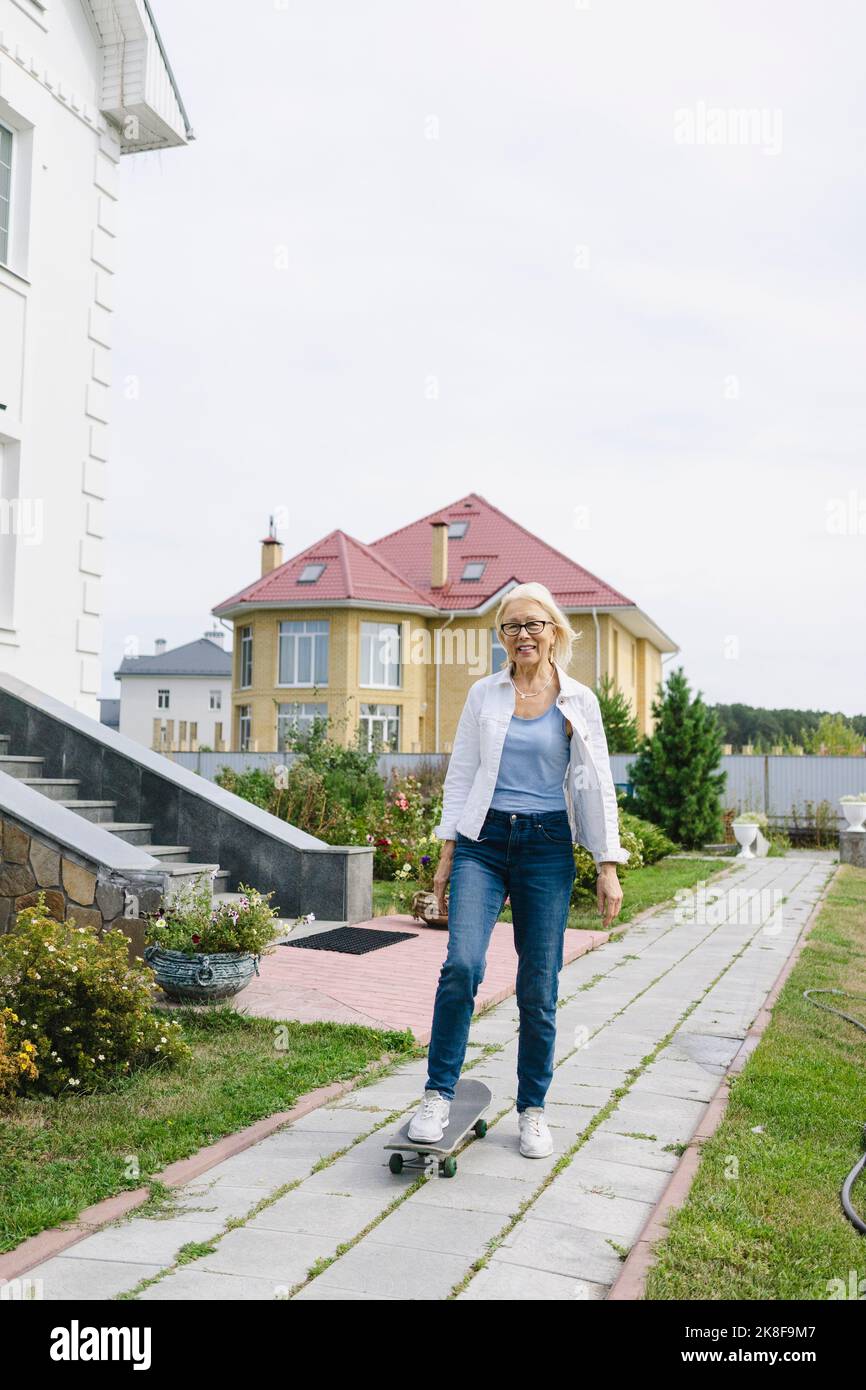 Senior woman standing outside hi-res stock photography and images - Alamy