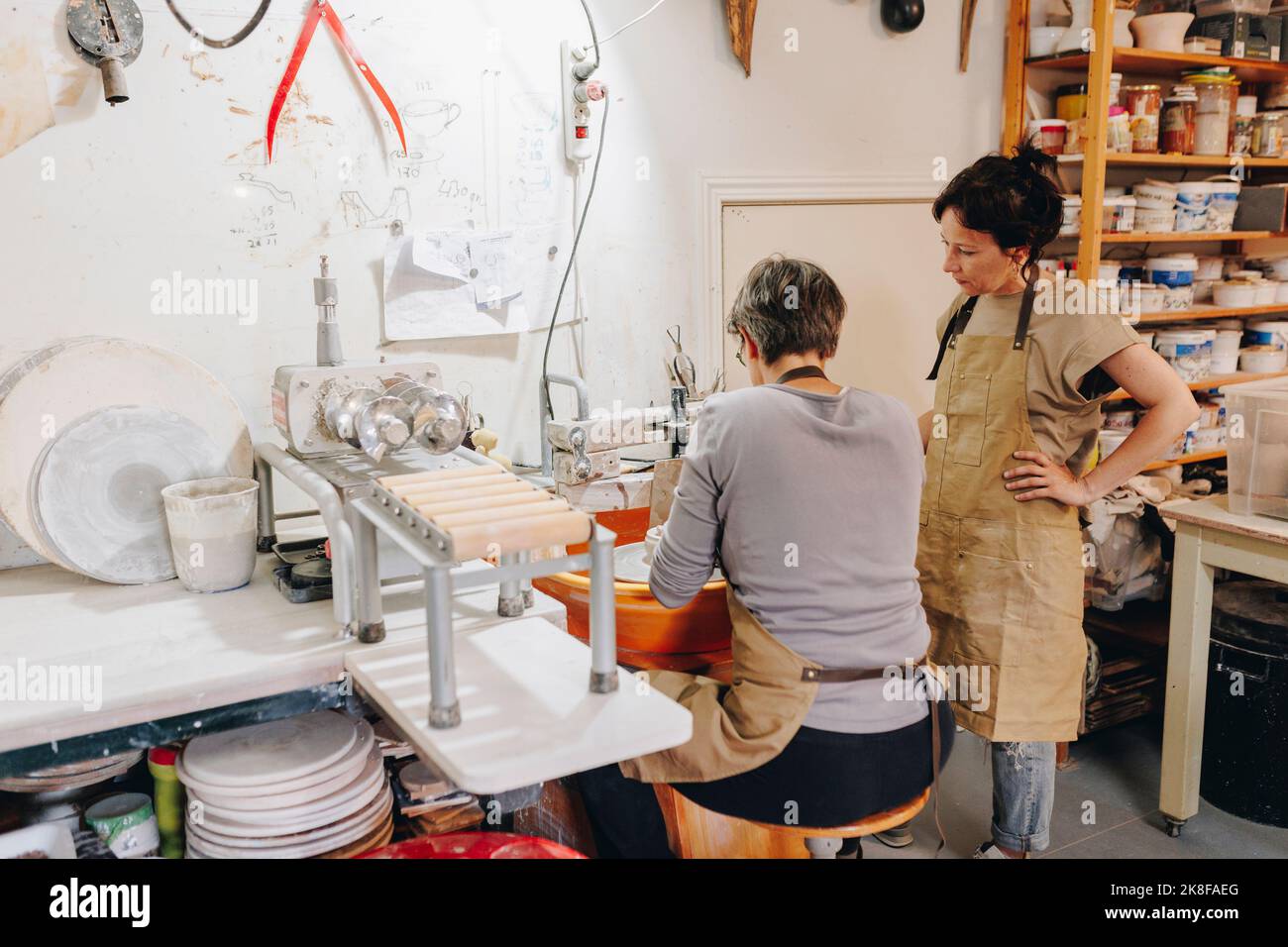 Entrepreneur with colleague working in ceramics workshop Stock Photo ...