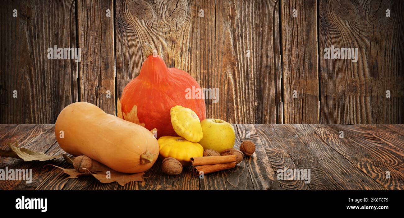 Autumn composition with fresh pumpkins and squashes on wooden ...