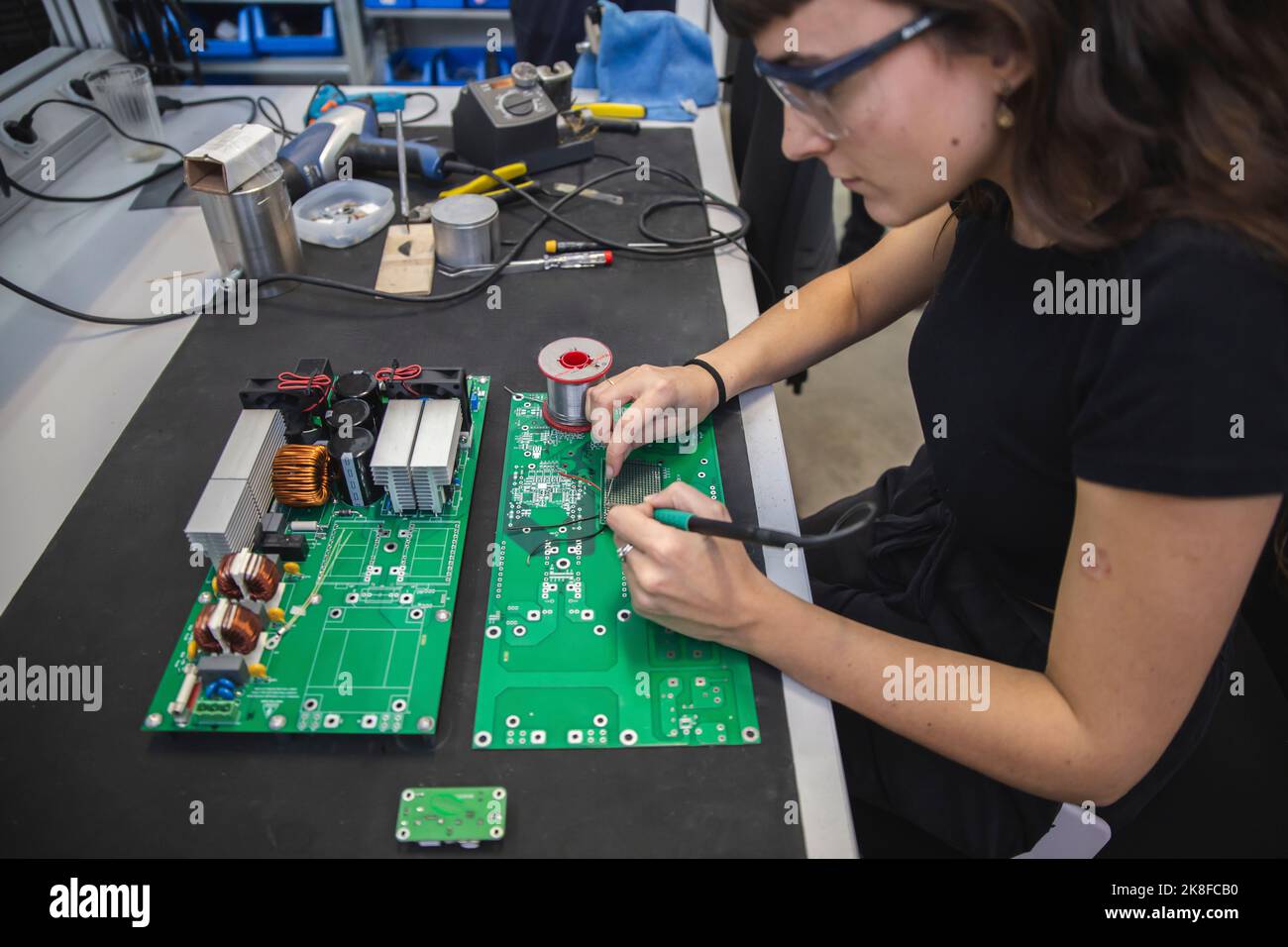 Technician soldering motherboard in electronics industry Stock Photo