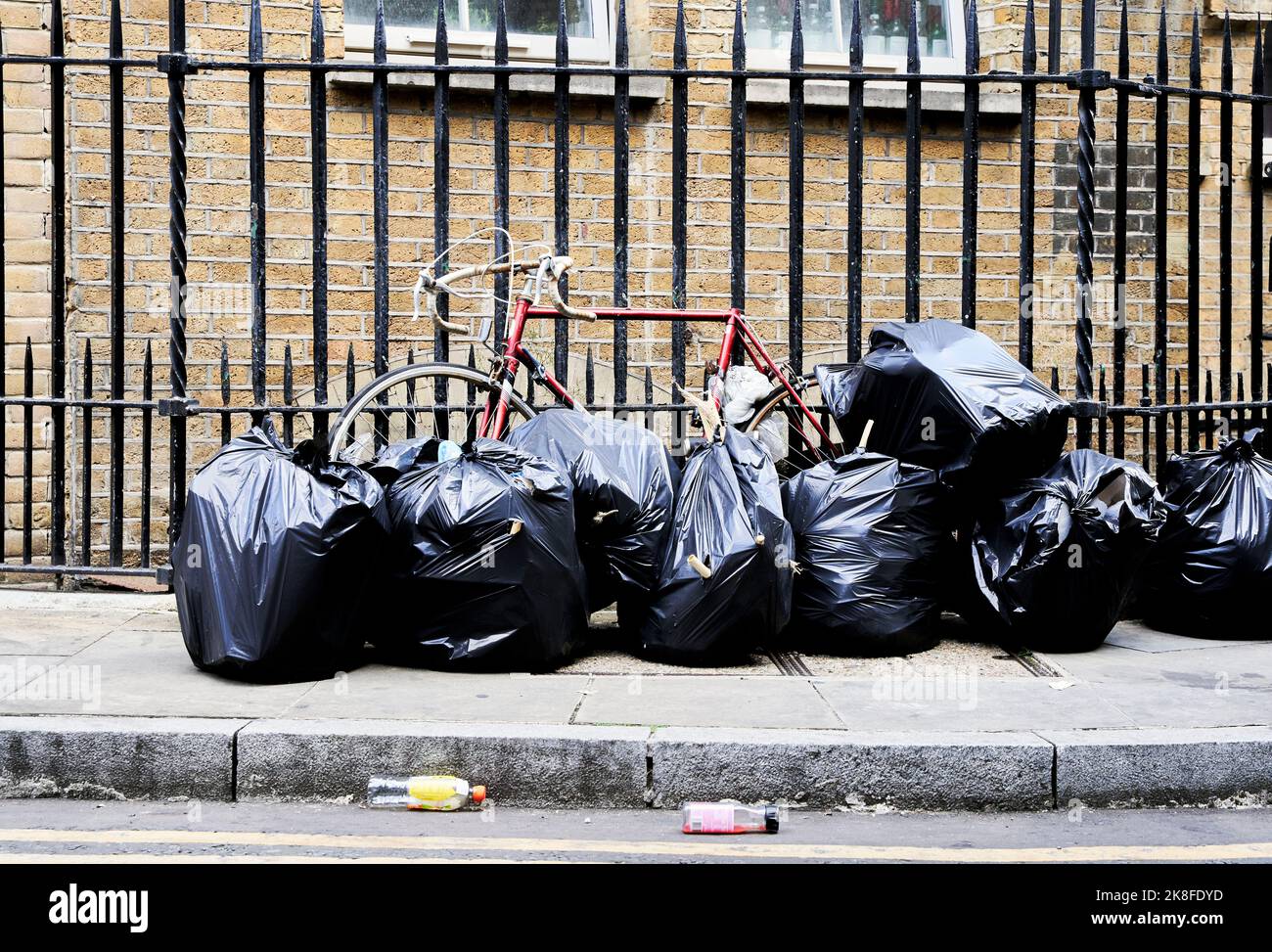 Garbage bags on footpath in city Stock Photo