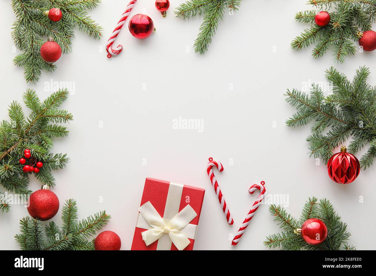 Frame made of fir tree branches and Christmas decorations on white ...