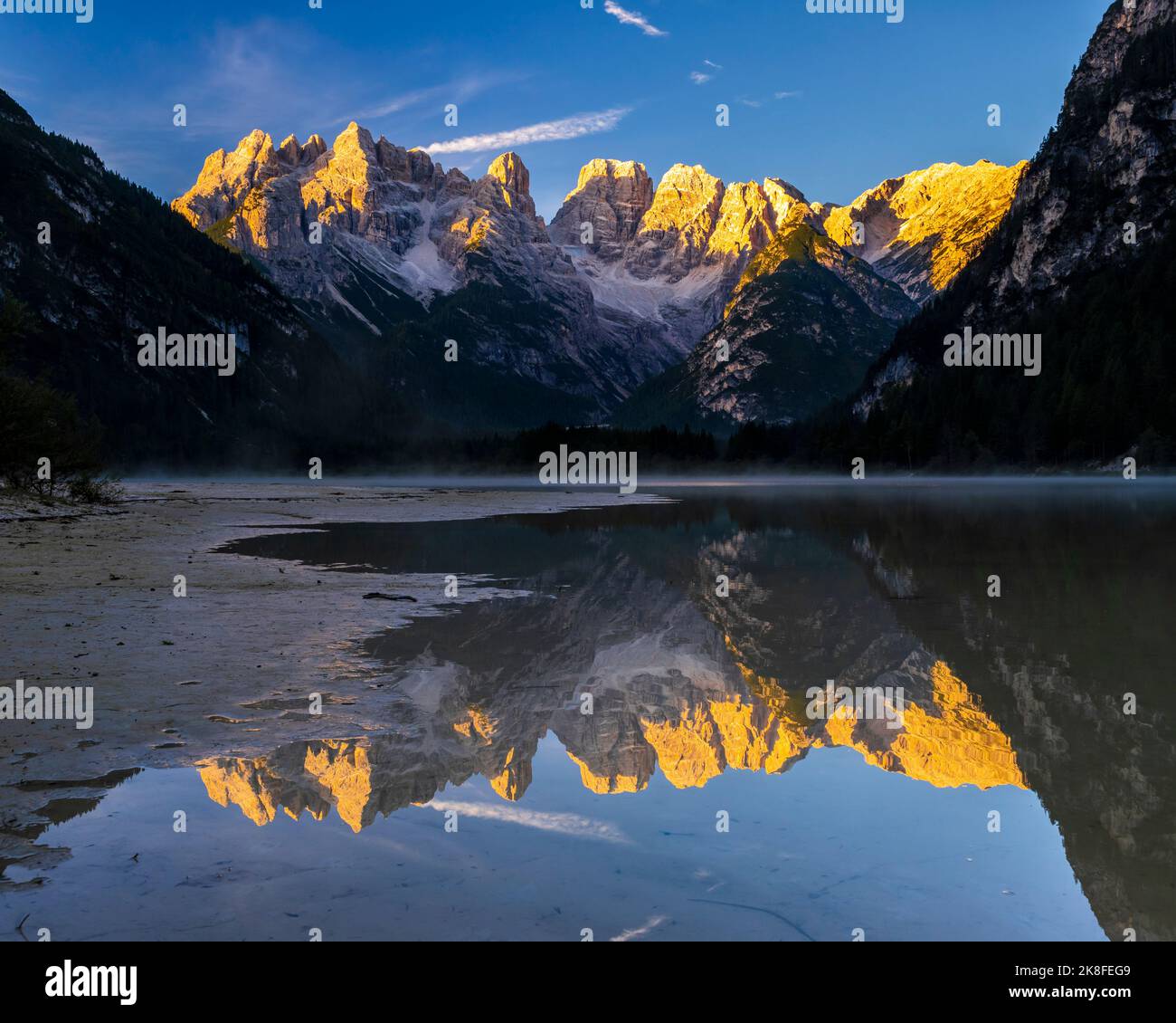 Italy, Trentino-Alto Adige/Sudtirol, Mountains reflecting in Lago di Landro at dusk Stock Photo