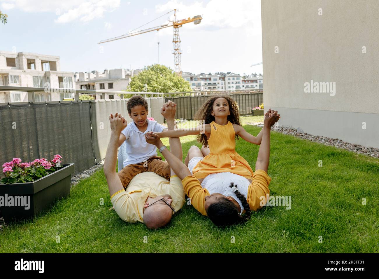 Family two children lying on grass hi-res stock photography and images ...