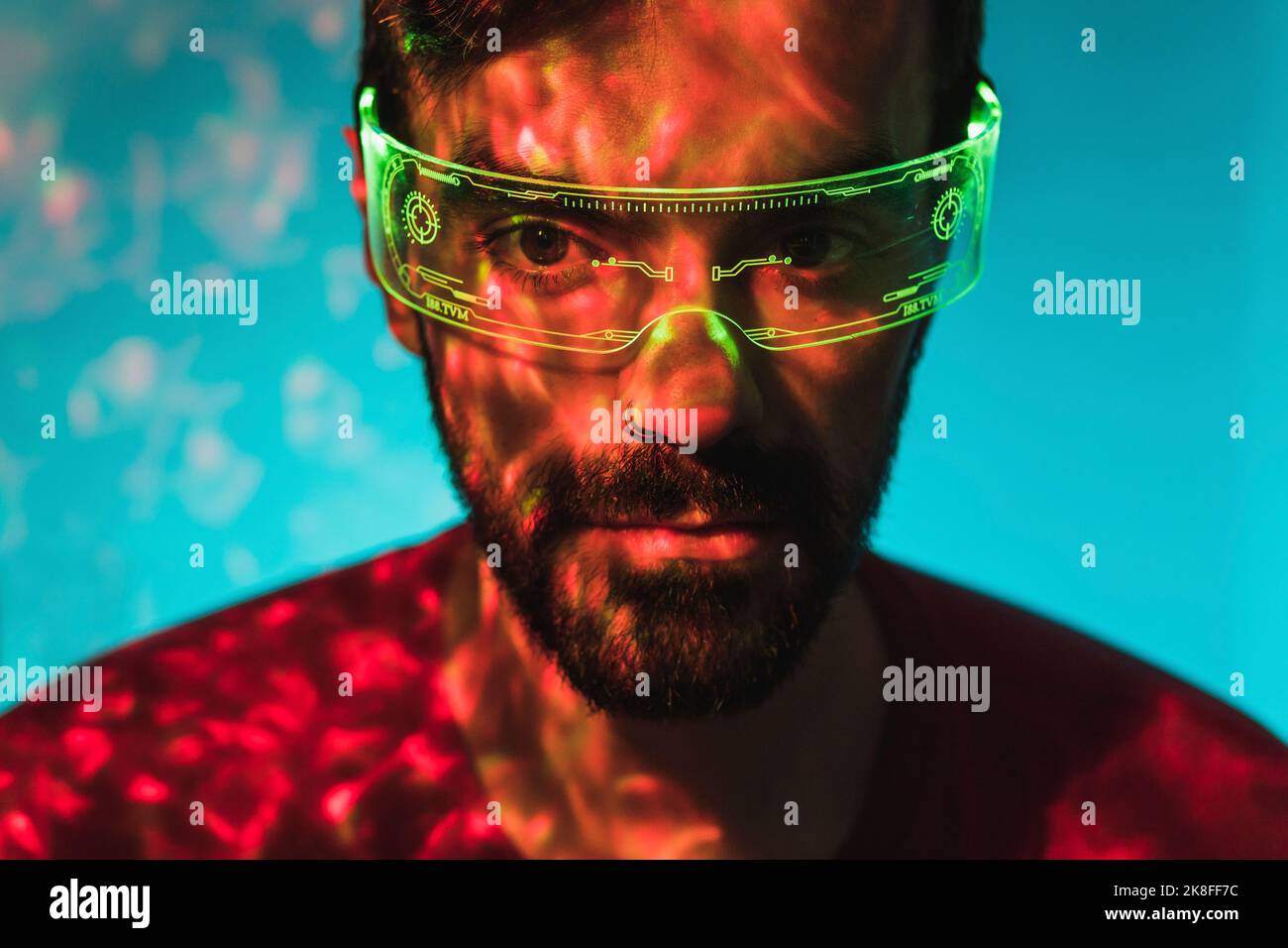Man with nose ring wearing green smart glasses Stock Photo