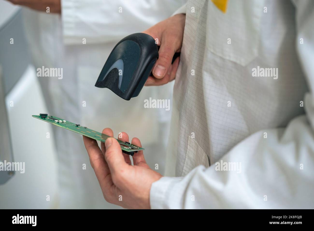 Engineer scanning circuit board with bar code scanner Stock Photo