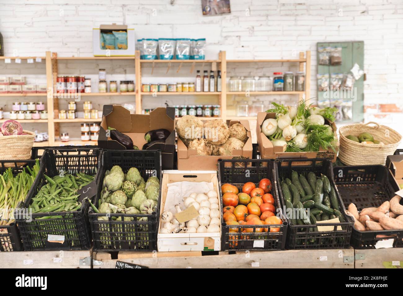 Fresh vegetables arranged in crates at greengrocer shop Stock Photo