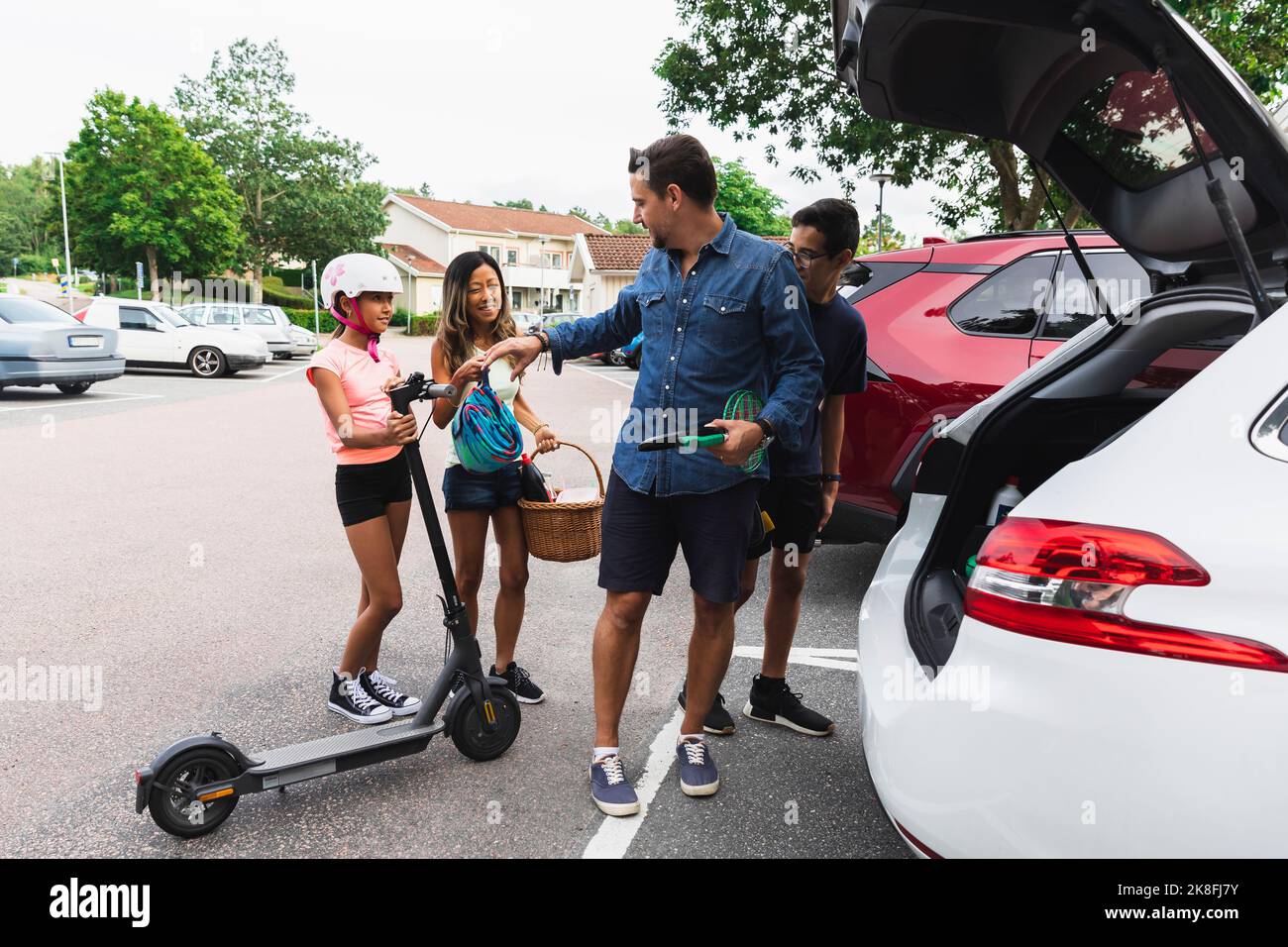 Family loading stuff in car trunk at parking lot Stock Photo Alamy