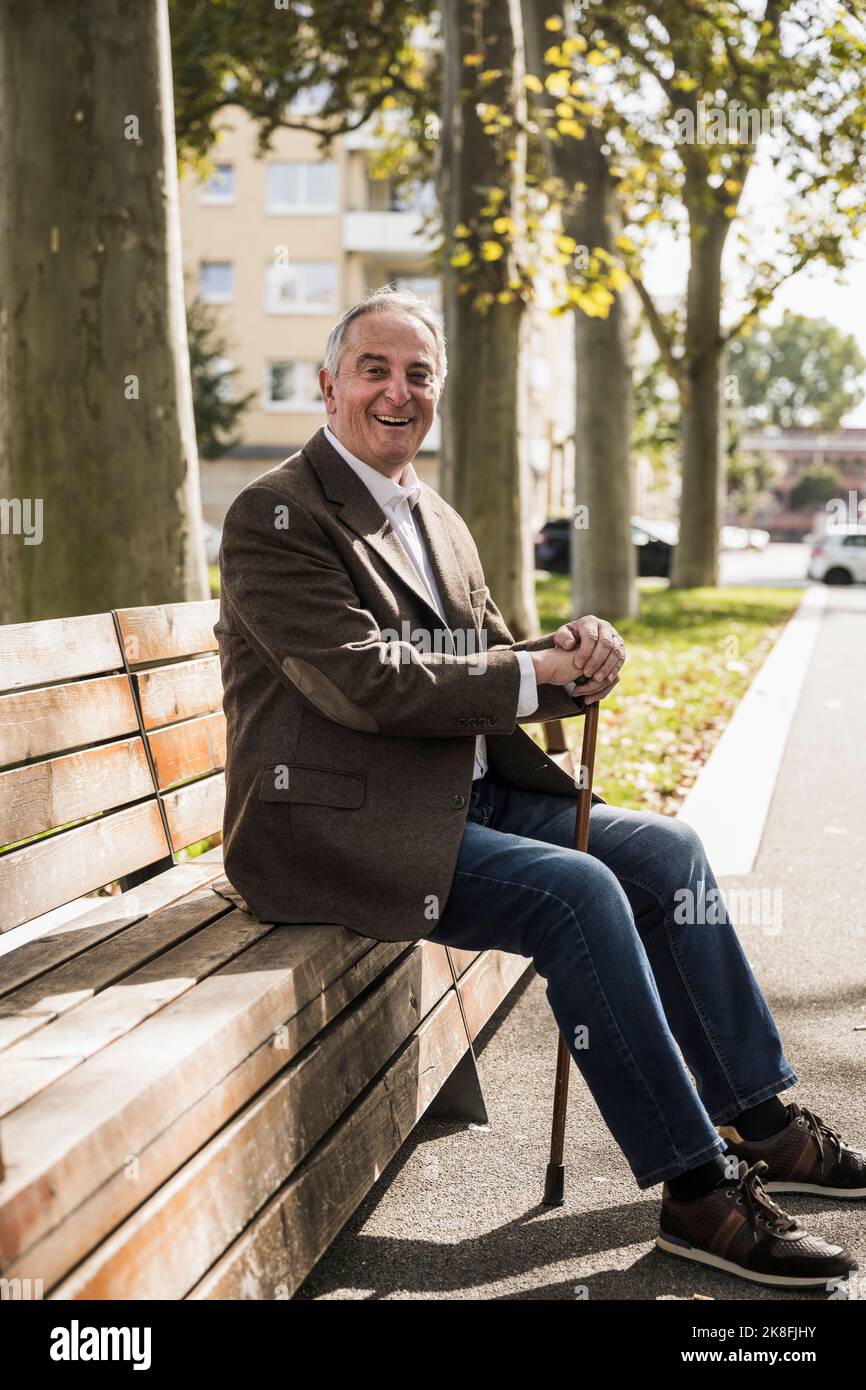 Happy senior man holding cane hi-res stock photography and images - Alamy