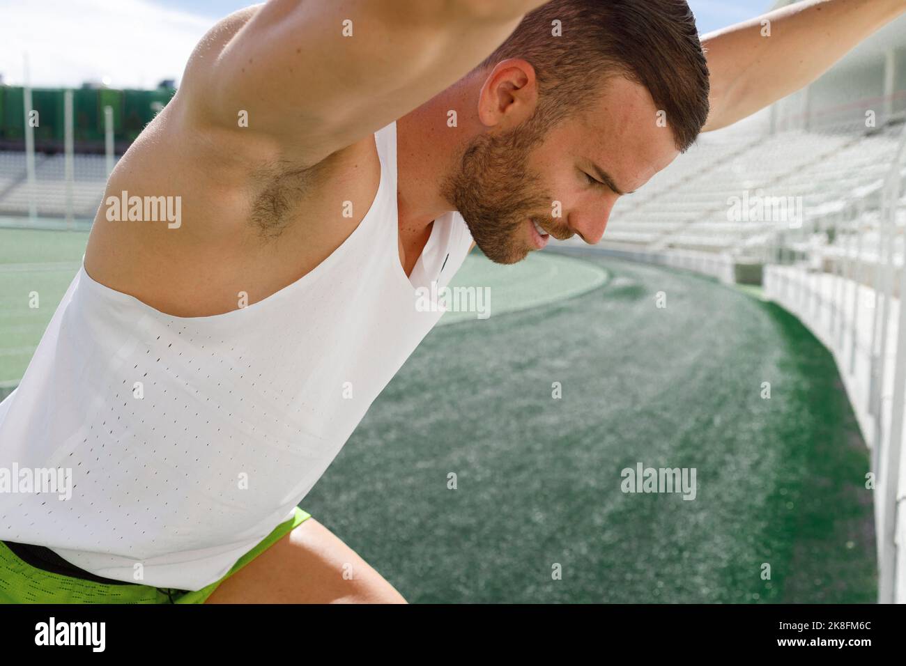 Athlete doing warm up exercise at sports field Stock Photo Alamy