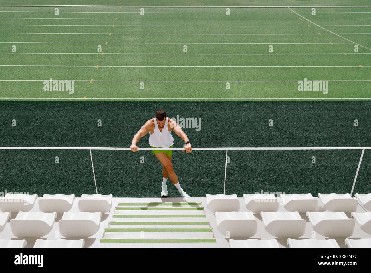 Athlete doing warm up exercise on running track Stock Photo Alamy