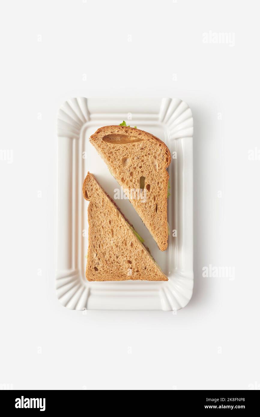 Brown bread sandwich on tray against white background Stock Photo