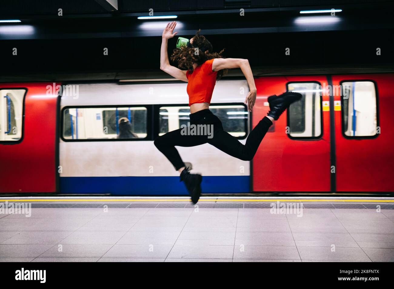 Woman jumping in front of train at subway station Stock Photo Alamy