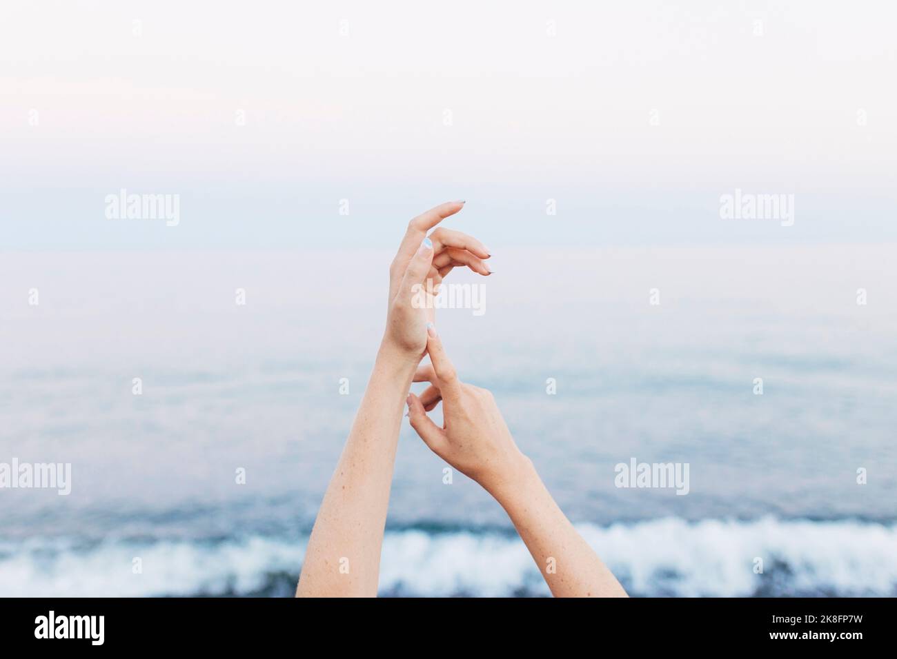 Hands of woman in front of sea Stock Photo