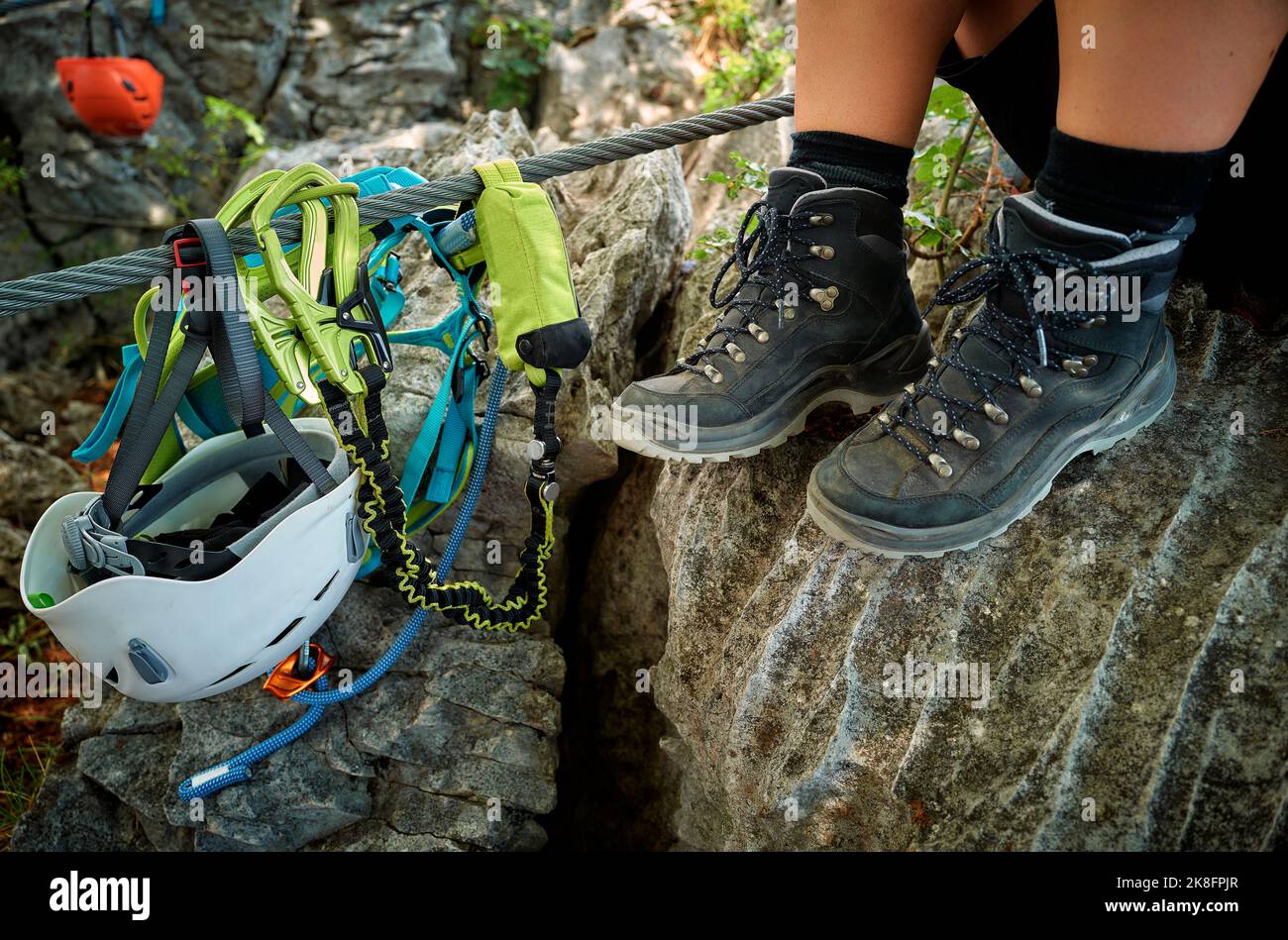 Legs of woman wearing hiking boots by climbing equipment rock Stock Photo Alamy