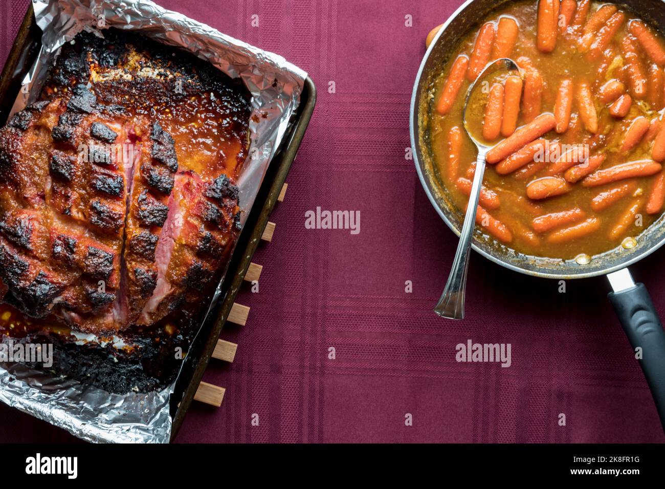 Top down view of roasted smokey picnic ham served with sauteed carrots Stock Photo Alamy
