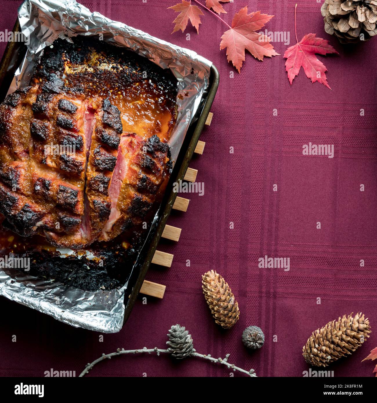 A roasted smoked picnic ham for Thanksgiving with copy space to the