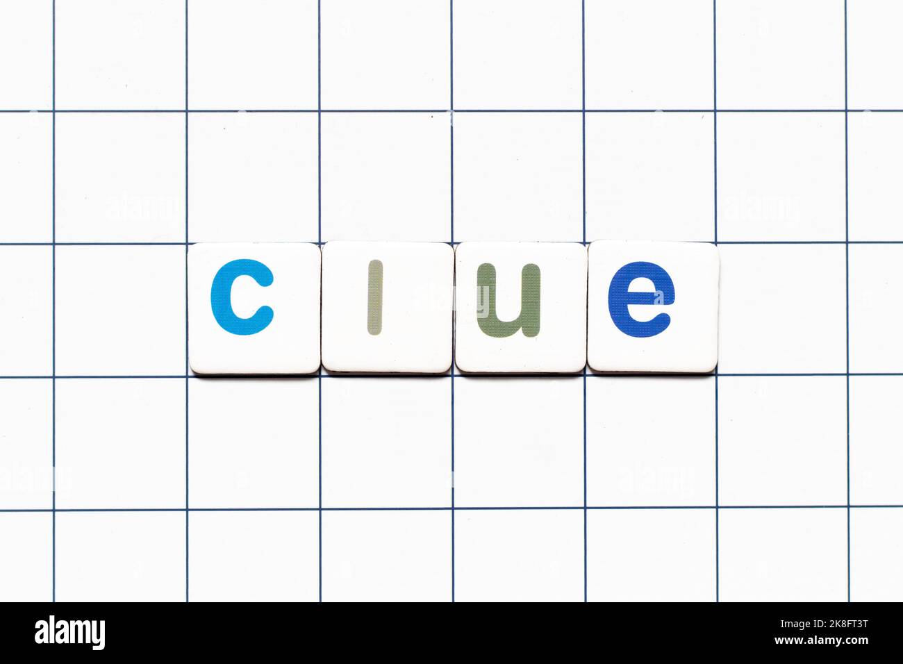 Colorful tile letter in word clue on white grid background Stock Photo Colorful tile letter in word clue on white grid background Stock Photo