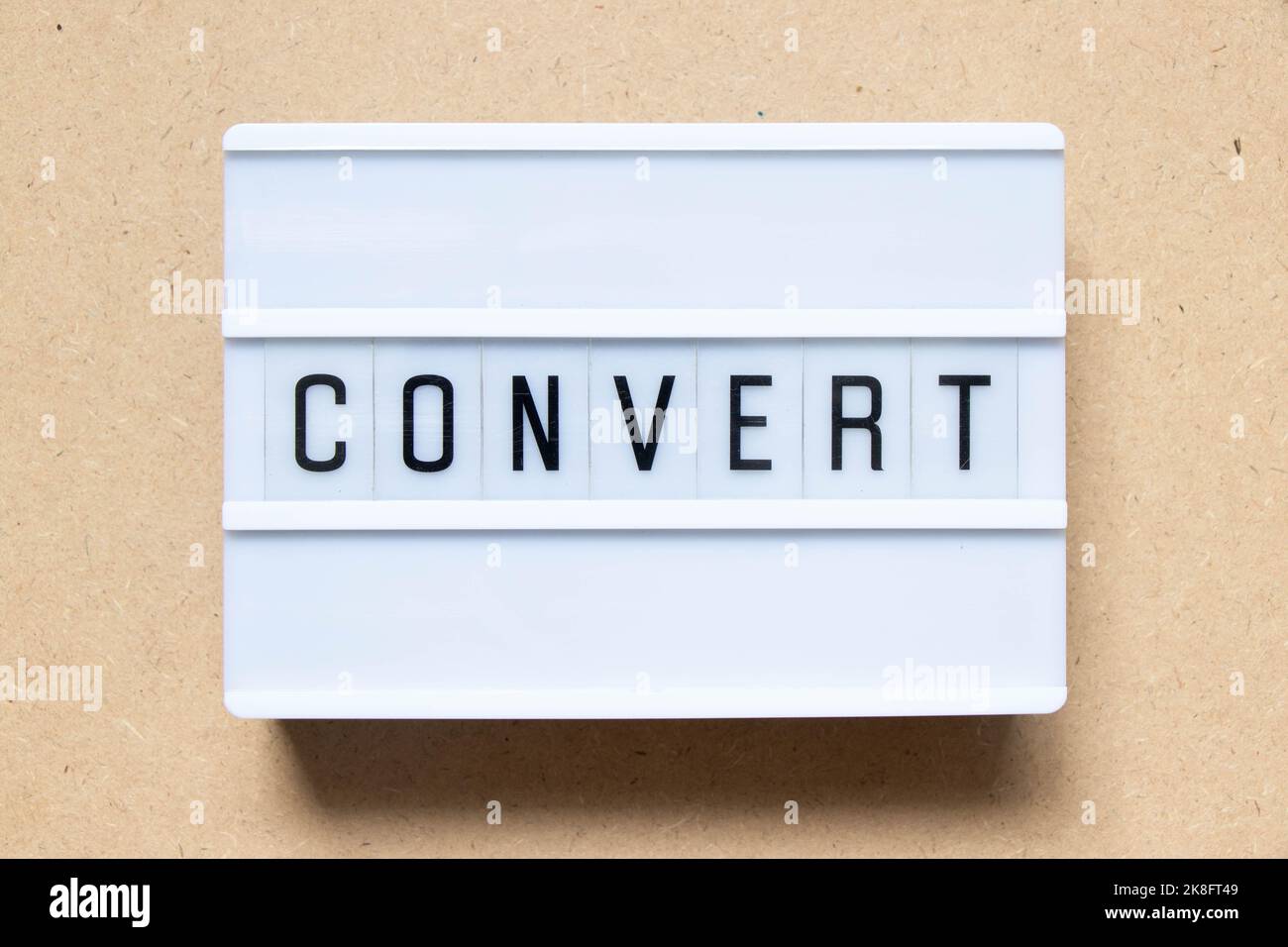 Lightbox with word convert on wood background Stock Photo