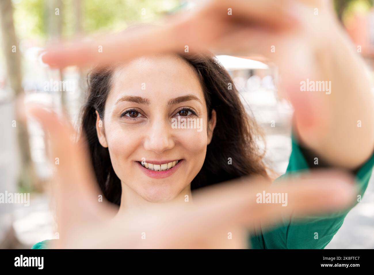  Happy woman making finger frame with hands Stock Photo - Alamy